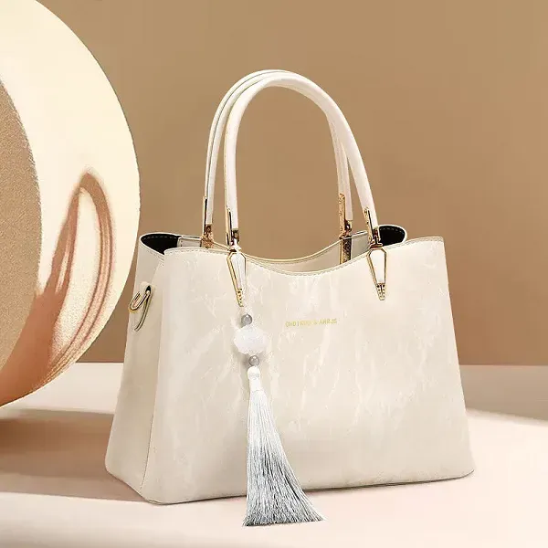 Elegant Textured Handbag with Tassel Charm