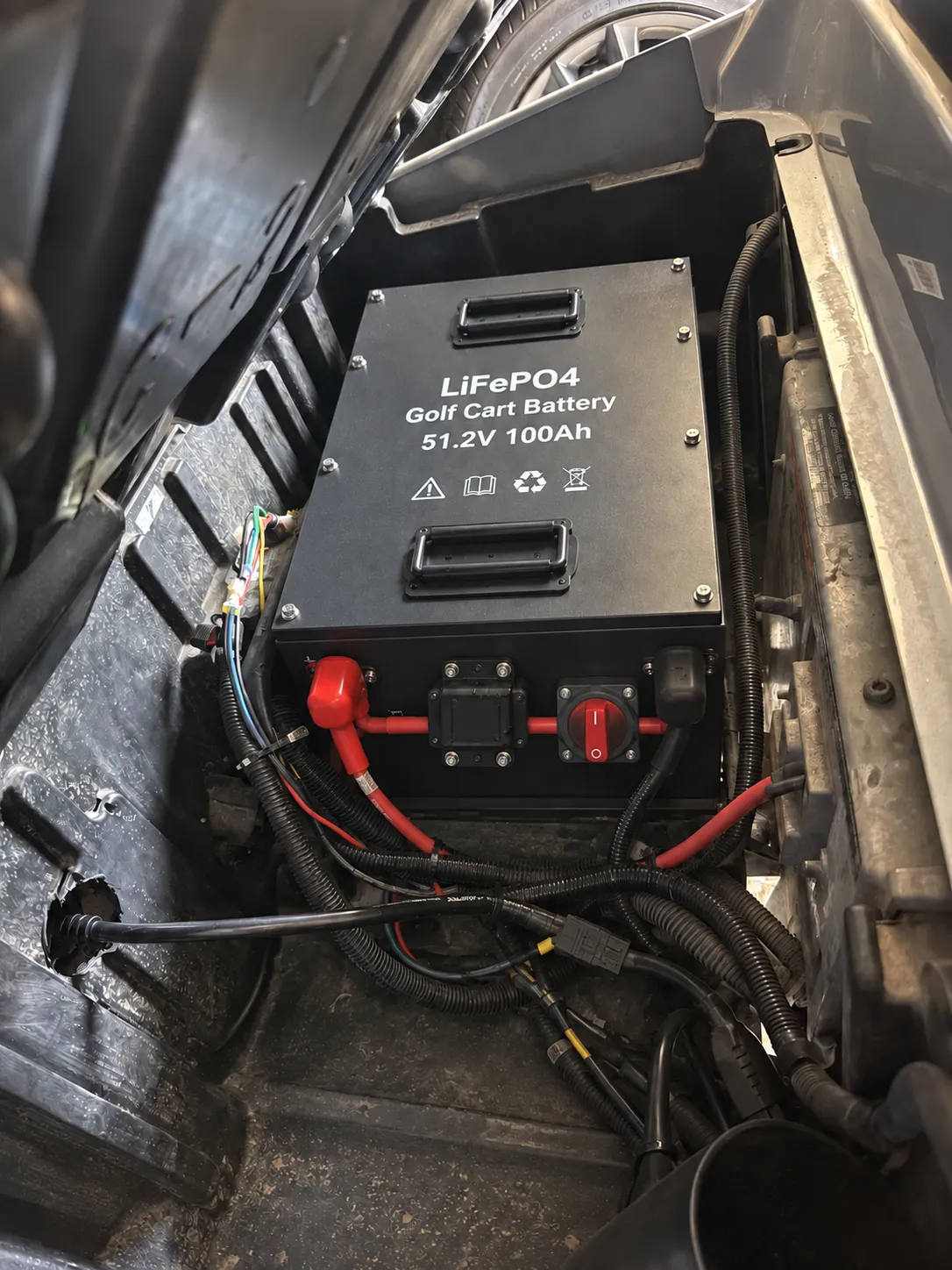 51.2V 100Ah LiFePO4 battery installed in a compatible 48V E-Z-GO RXV golf cart