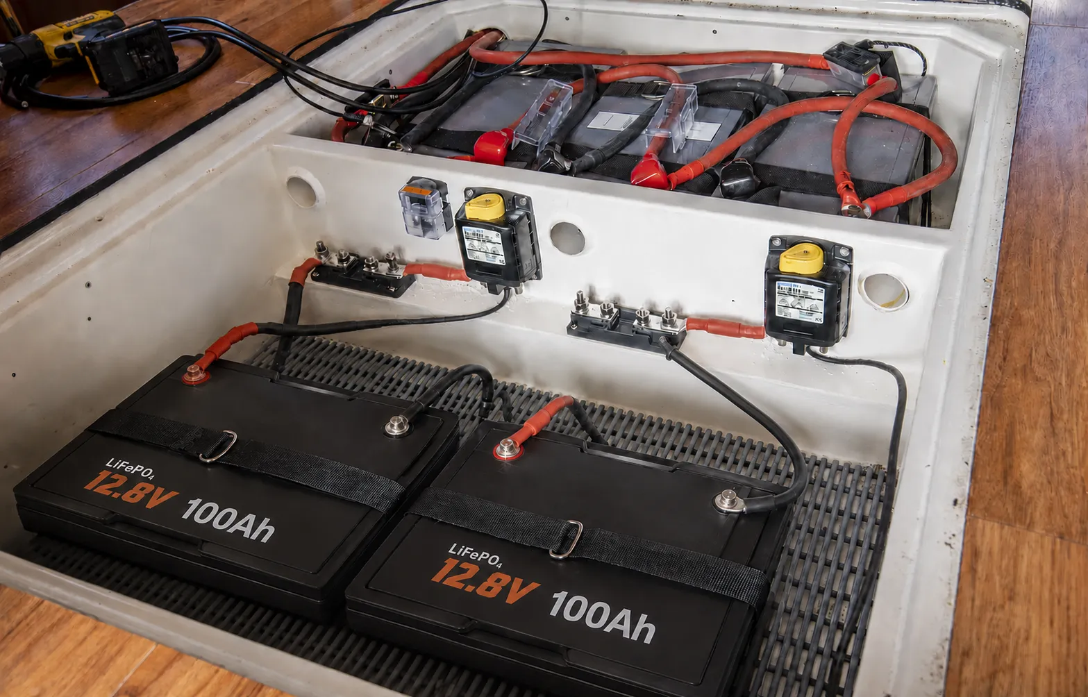 Sailboat LiFePO4 house battery connected to inverter shore charger solar controller and DC-DC charger