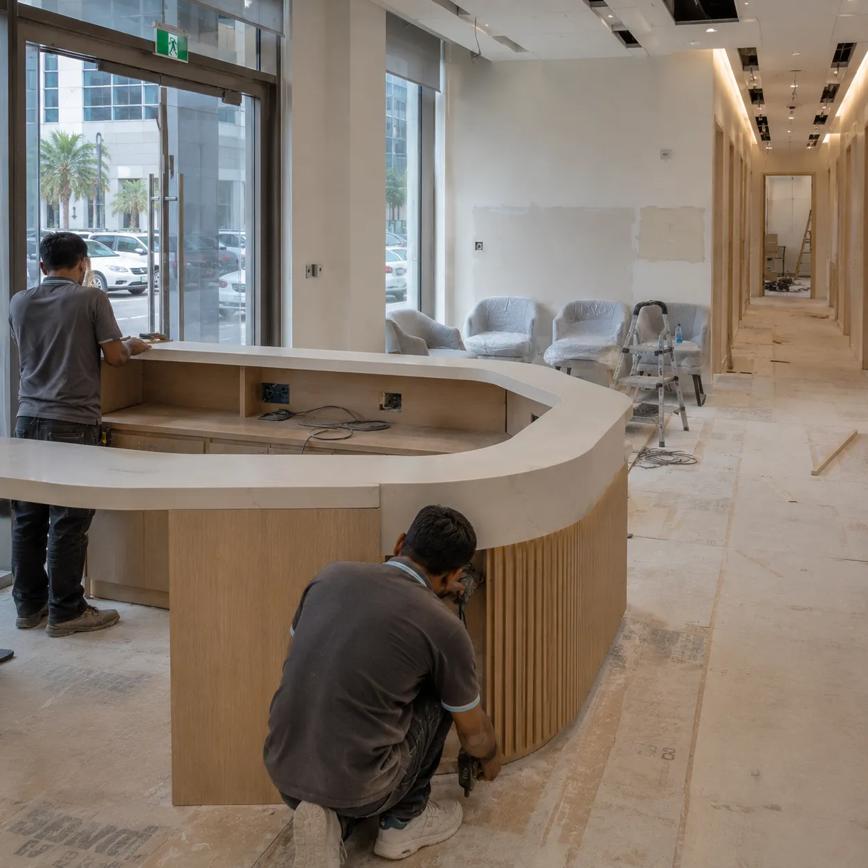 Ceiling boards being installed in a clinic corridor