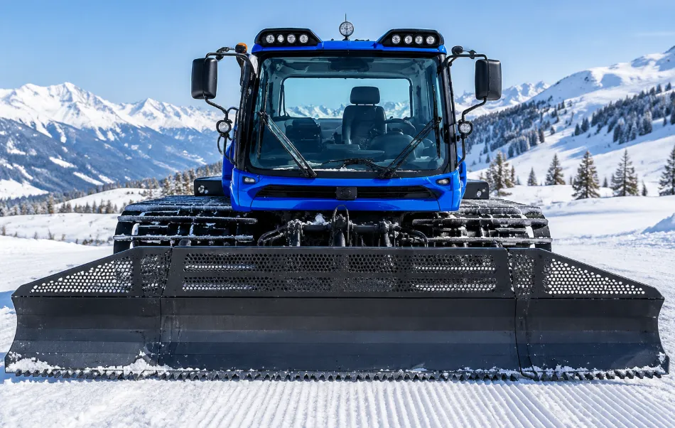 X300 Electric Snow Groomer Battery Application | TUORDE Blue tracked snow groomer with a front snow blade in a snowy mountain environment